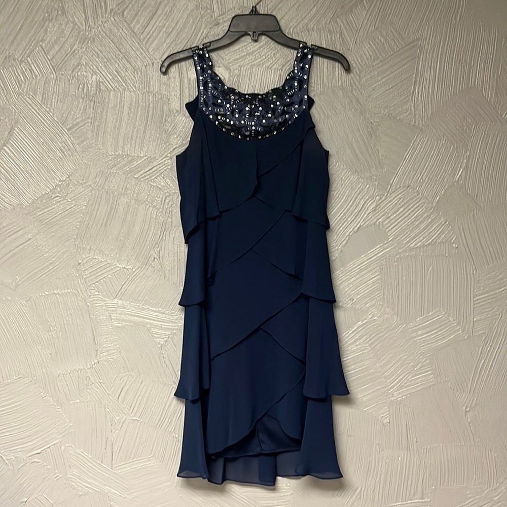 Macys formal dress. Worn once. Layered detailing with unique neckline.